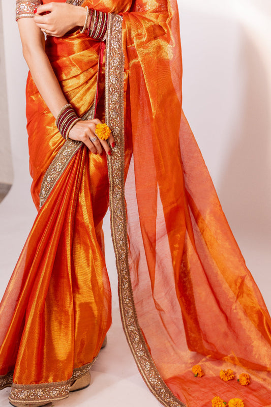Taraash – Orange Tissue Saree with Zari Embroidered Border