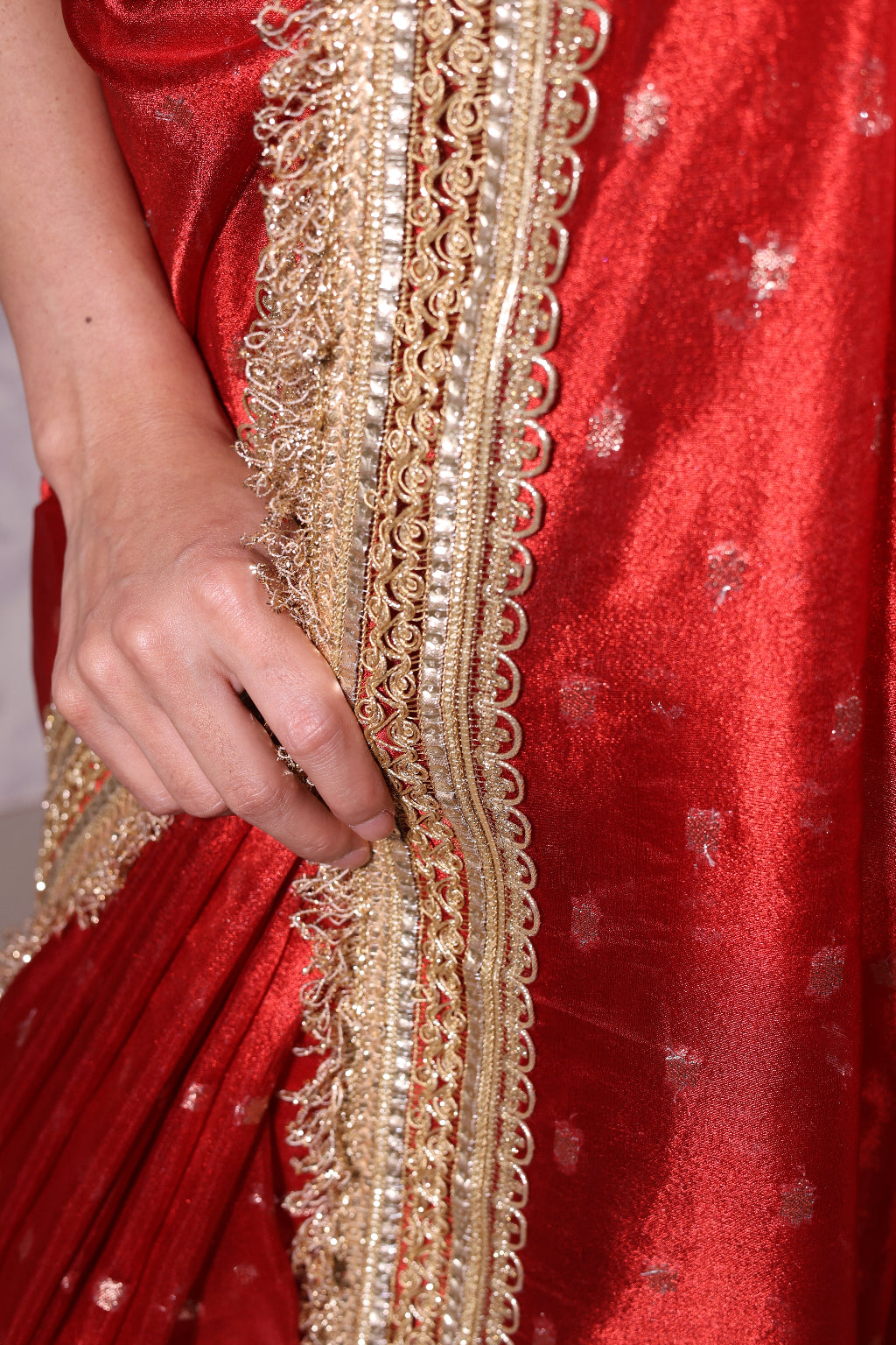 Kumkum – A banarsi silk saree in auspicious red, with shimmering golden butis and an intricate zari border.