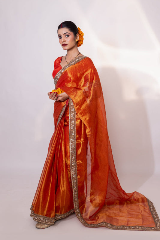 Taraash – Orange Tissue Saree with Zari Embroidered Border