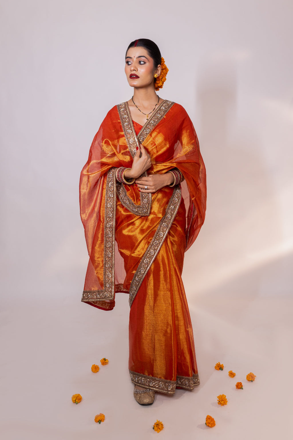 Taraash – Orange Tissue Saree with Zari Embroidered Border