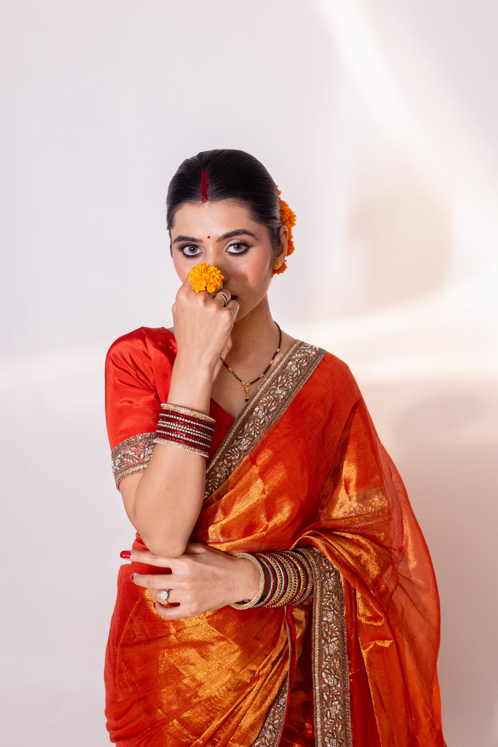Taraash – Orange Tissue Saree with Zari Embroidered Border