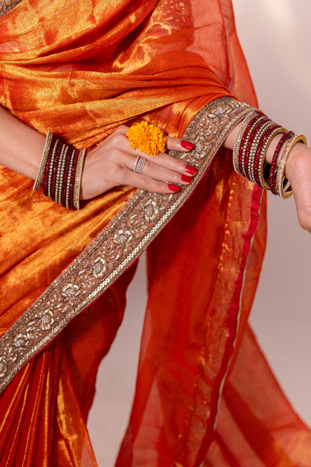 Taraash – Orange Tissue Saree with Zari Embroidered Border