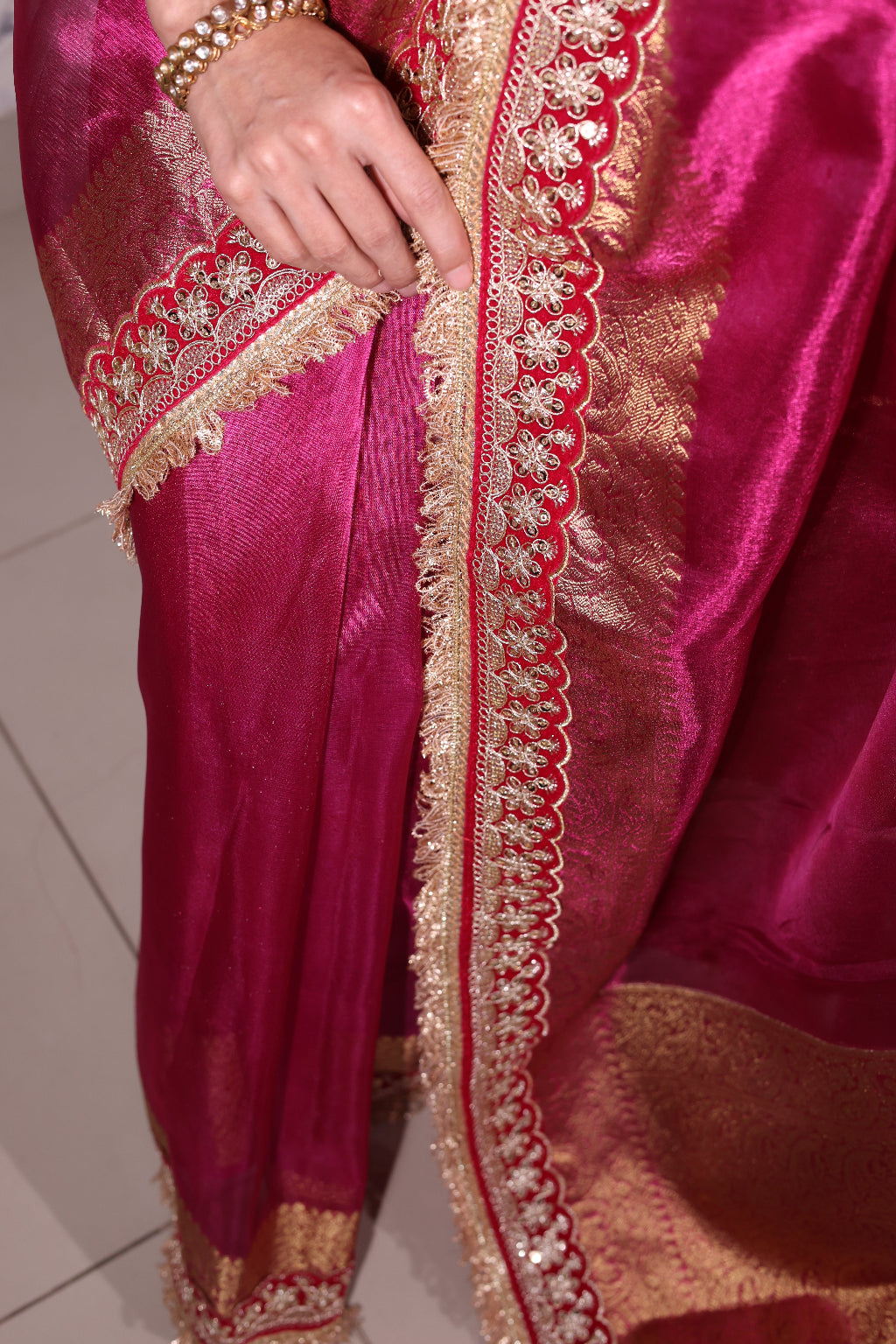 Rajasi – A majestic banarsi tissue silk saree in a rich fuchsia tone, with red-golden zari work