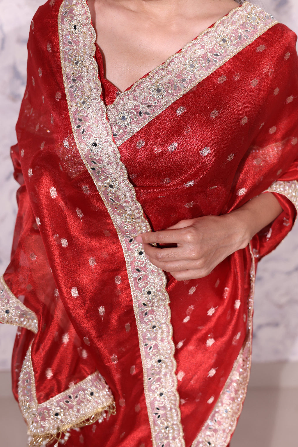 Shagun – A classic red banasri tissue saree with sparkling butis and a beautiful intricate border.